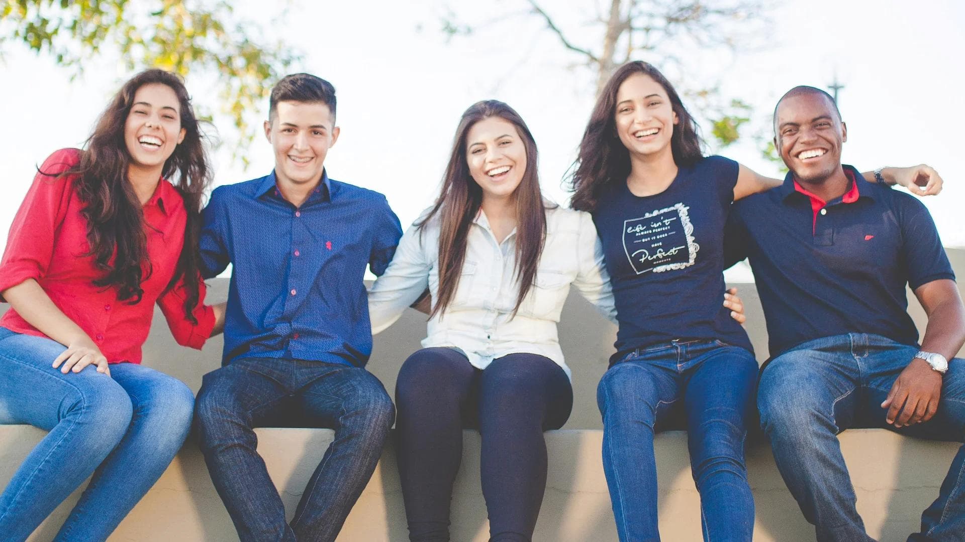 a young man sitting in a library reading a book